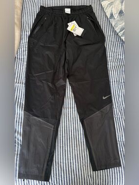 Nike Black Women's Track Joggers with Mesh Panels and Reflective Swoosh